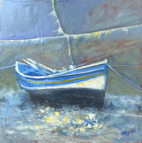 A classic blue and white Double Ender fishing boat floats in Staithes Beck.