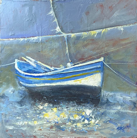 A classic blue and white Double Ender fishing boat floats in Staithes Beck.