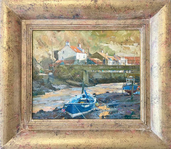 A striking view of Staithes Beck reflecting the golden light illuminating Cowbar.