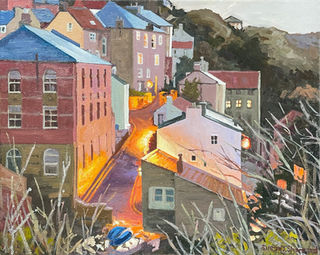 As dusk falls on Staithes the narrow lanes of Beckside are illuminated by street lamps and cottage windows.