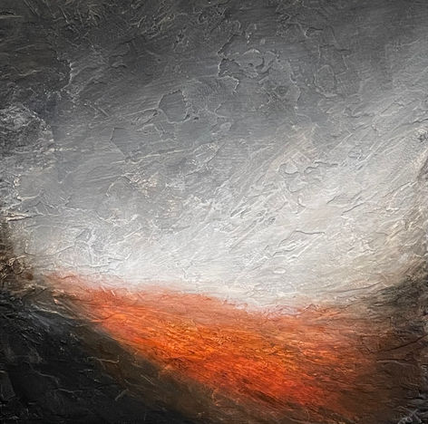 A distant hill glows orange against the monochromatic gloom of darkening clouds and shadowed land.
