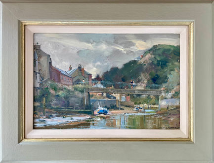 An unusual version of the classic view of Staithes Beck looking upstream towards the bridge and Beckside Cottages with a classic Staithes Double Ender boat in the middle distance.