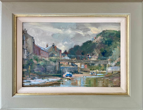 An unusual version of the classic view of Staithes Beck looking upstream towards the bridge and Beckside Cottages with a classic Staithes Double Ender boat in the middle distance.