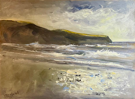 A view looking down over Sandsend beach at high tide.