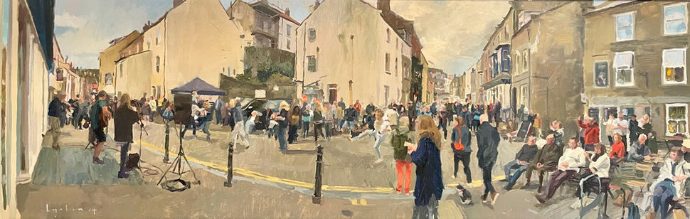 An expansive panoramic view of revellers dancing on the streets during Staithes Festival.