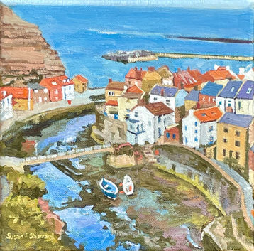 The classic Staithes view looking down onto Staithes Beck as it winds its way out to the harbour at low tide.