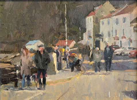 A view looking across the sea front, Staithes, including strolling visitors in front of a row of typical Staithes cottages. The cliff in shadow is in the background.