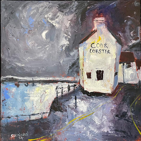 A dramatic moonlit view of the Cod and Lobster pub.