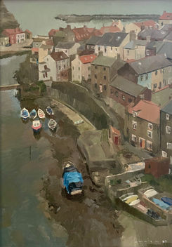 A dramatic view looking down over Staithes beck and beckside cottages on an overcast day.