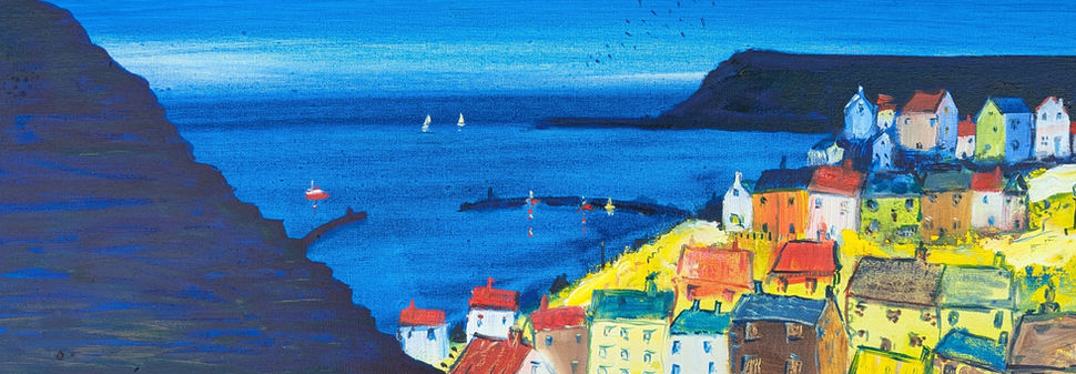 A nocturnal scene contrasting the yellow illuminated village with the dark blue cliffs, harbour and sea.