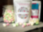 Two Foodnerd Petite Popmallow pouches with a glass jar and freeze-dried marshmallows on the table"