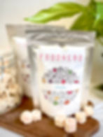 Foodnerd freeze-dried banana pouches on a table with freeze dried banana beside them
