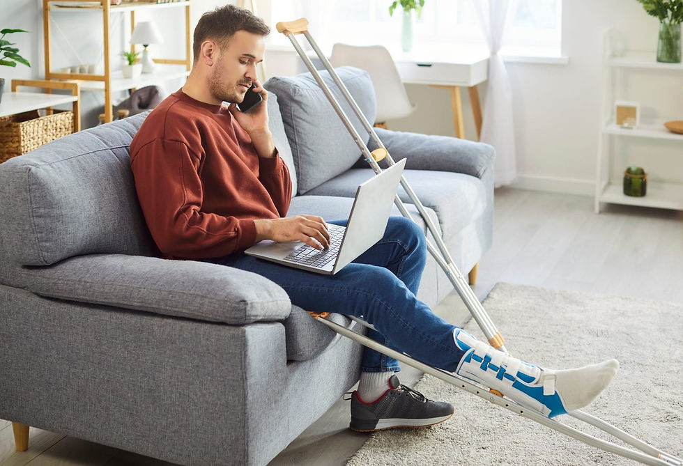 Person with an injured leg and crutches on the phone/computer scheduling a physical therapy appointment without a referral in Montana.