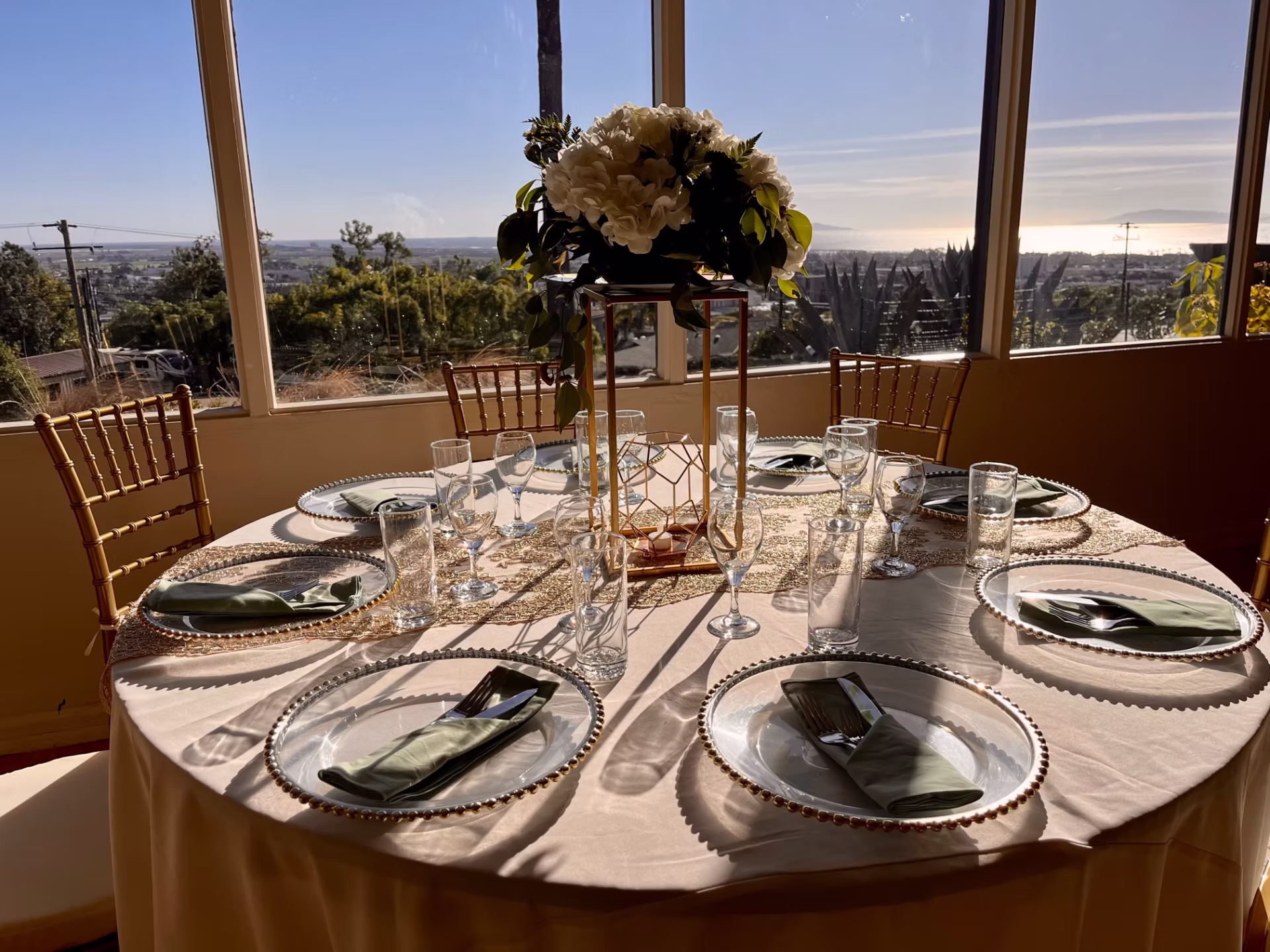 A beautifully appointed table at the Poinsettia Pavilion has stunning views of the Pacific Ocean