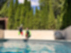 Thumbnail: Two kids in the air jumping into a pool wearing SwimHumyn UPF sun protective kid's swimming sets