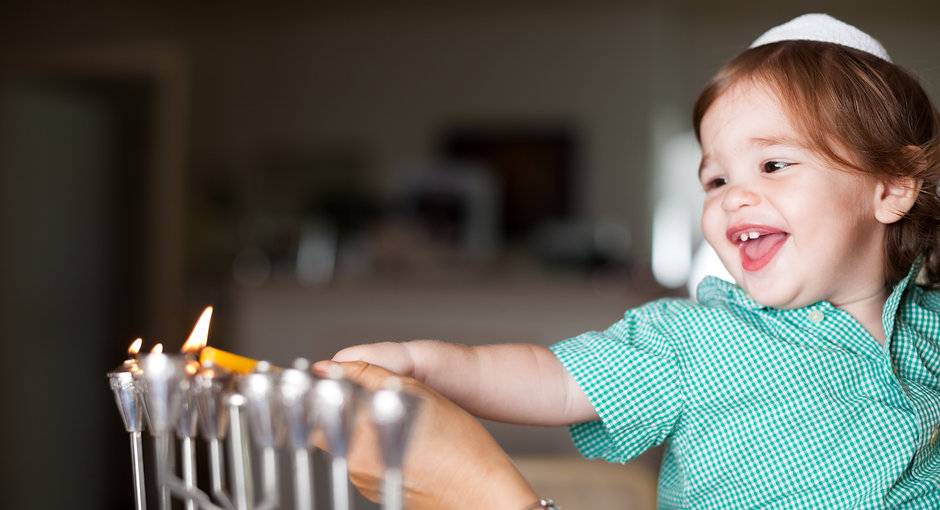 Mother and Baby Lighting a Menorah