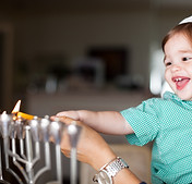 Mother and Baby Lighting a Menorah