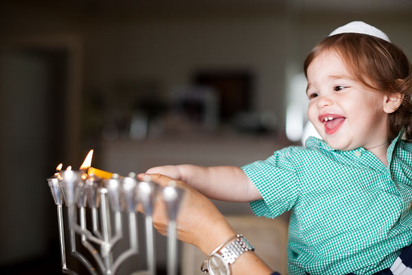 Mother and Baby Lighting a Menorah