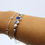 Thumbnail: Blue Topaz, Blue Quartz, and Freshwater Pearl Latching Cuff- side view on model