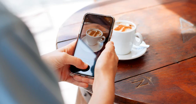 girl-taking-picture-cup-coffee_136533-69.webp