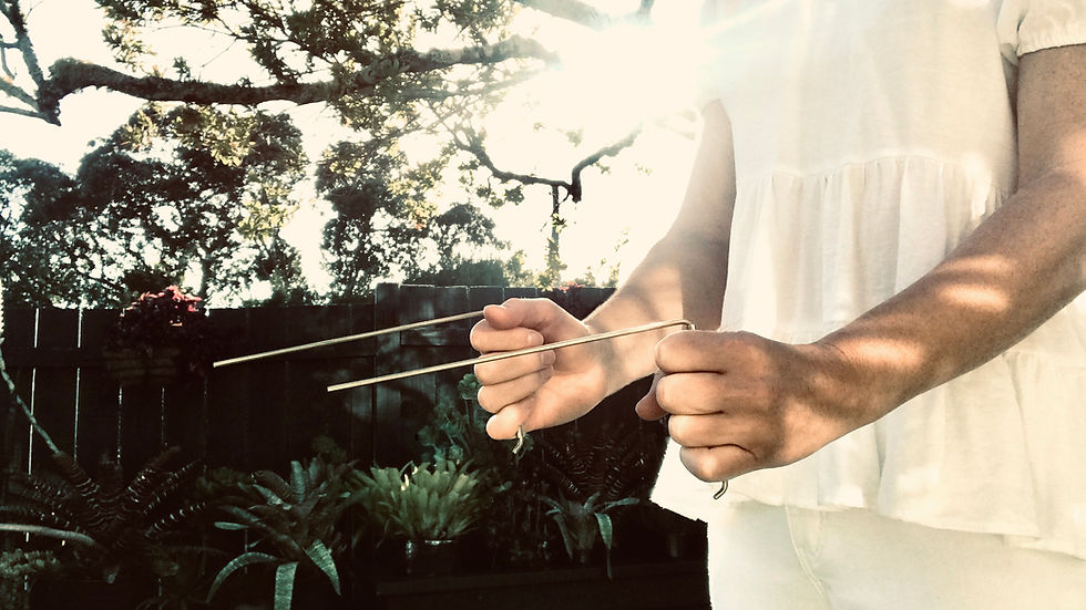 Demonstrating my handmade brass dowsing rods.