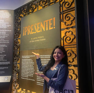 Jaquelin Barajas in front of the ¡Presente! poster in the Smithsonian American History Museum.