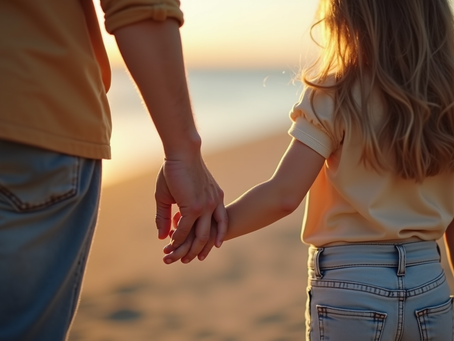 Young child holding a parents hand to get comfort
