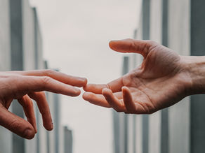 A couple reaching for each other after betrayal to rebuild trust