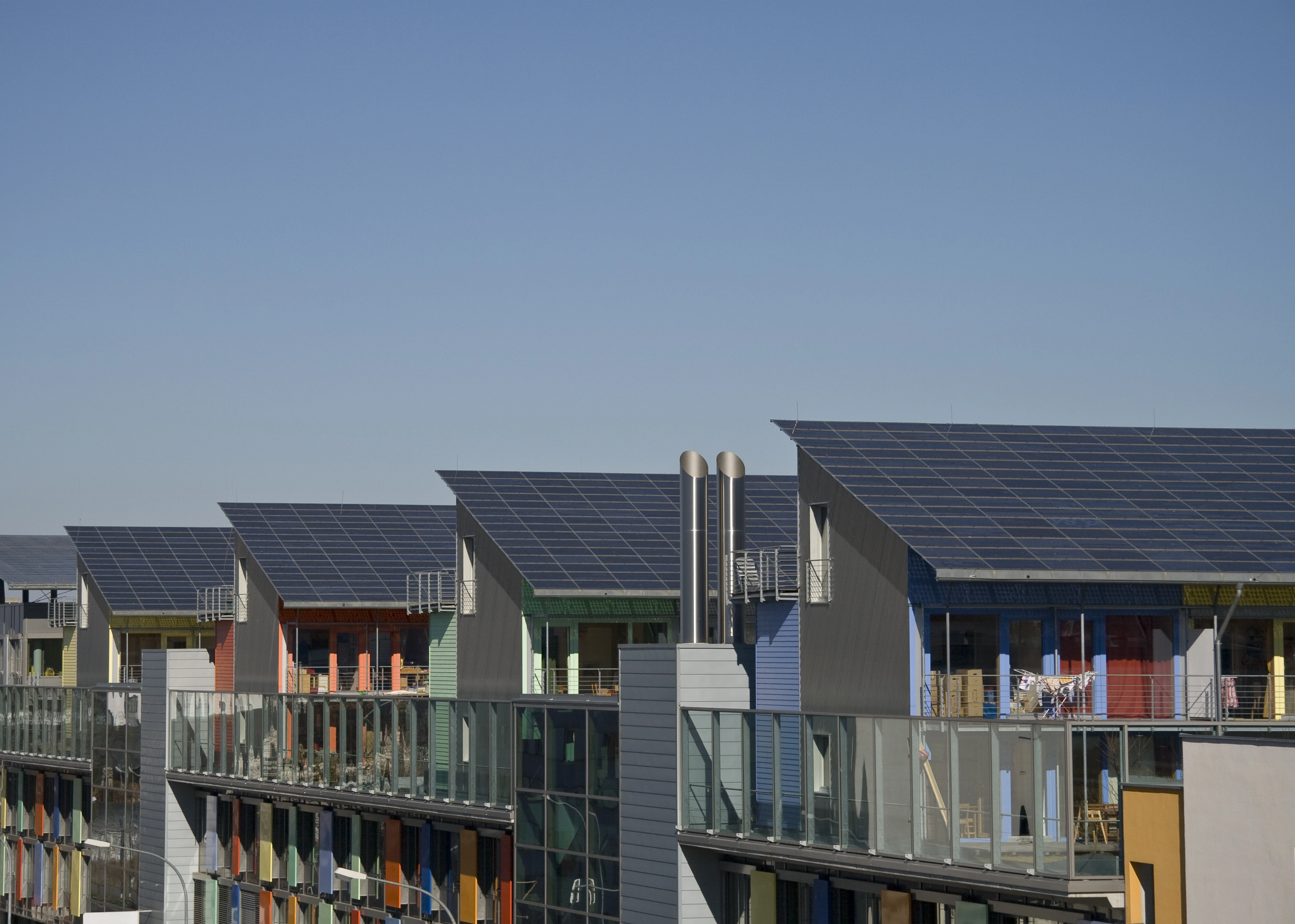 Neighborhood of houses with solar roofs generating clean electricity