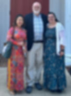 Tracy Duong, stands with Rod Owen, and Gabby Moore in front of Westminster's chapel.