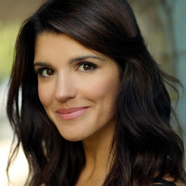 A close up picture of Natalie Anderson against a blurred background.