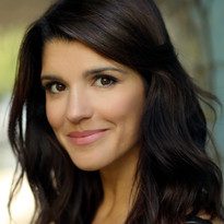 A close up picture of Natalie Anderson against a blurred background.