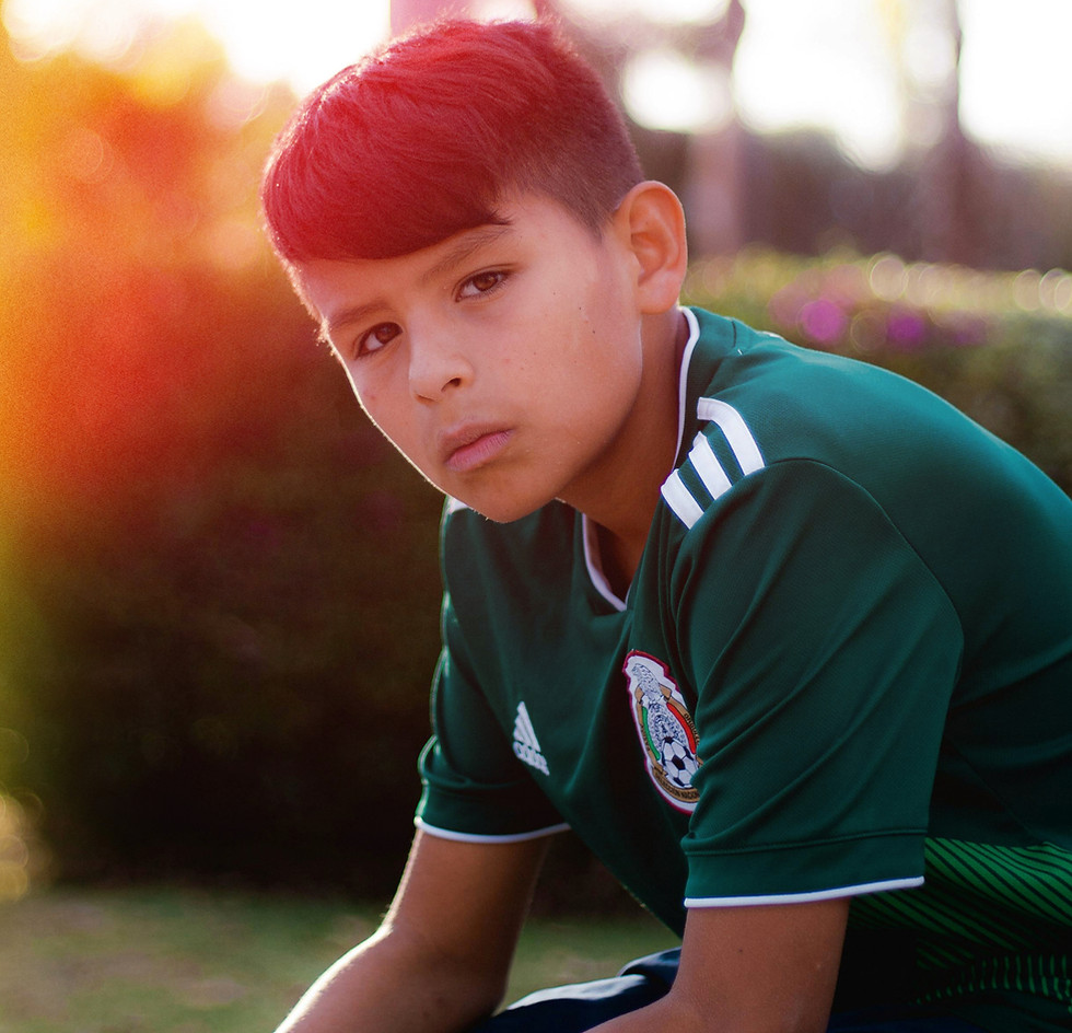 Young boy in a Mexico soccer jersey sharing a brand story