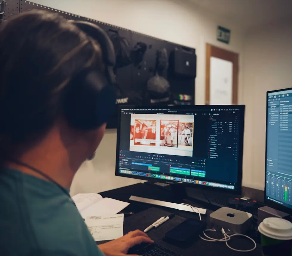 Video editor working on a project using computer screens in the studio