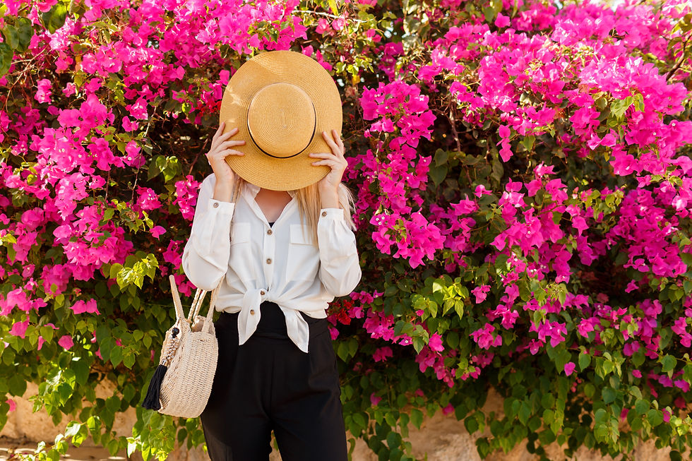 Vibrant image of healthy women holding a straw hat, surrounded by beautiful pink flowers, showcasing a harmonious blend of nature and well-being