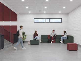 Green and burgundy modular Kae seating in a student lounge, with college students sitting and talking.