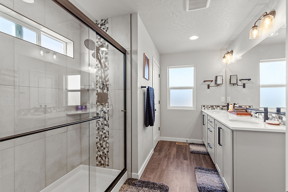 Master bathroom with glass shower, dual vanity in home for sale in Idaho.