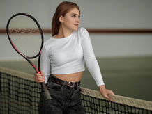 Image of a woman holding a tennis racket