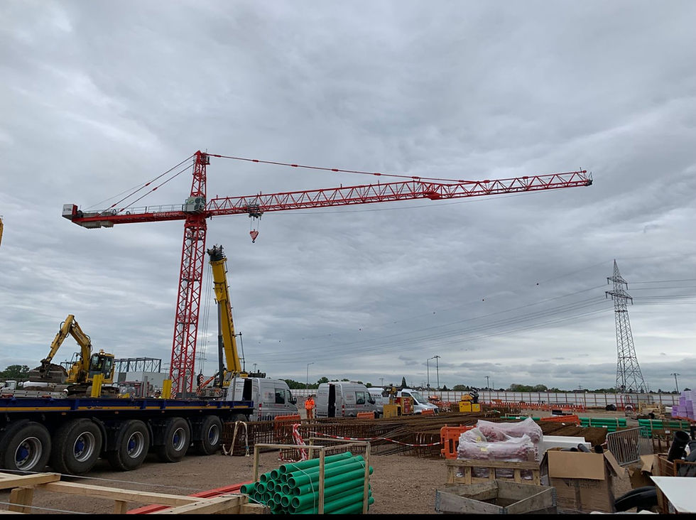 High angle view of a tower crane lifting materials on a construction site