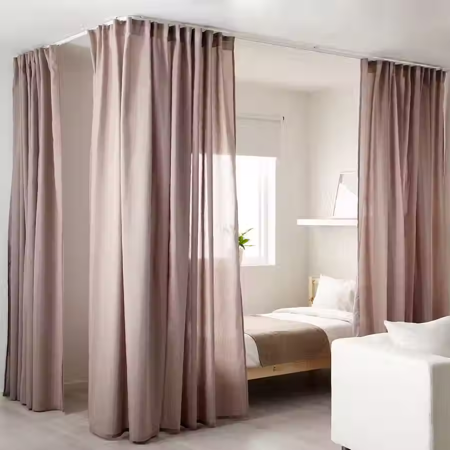 Small studio with curtains creating privacy around the bed.