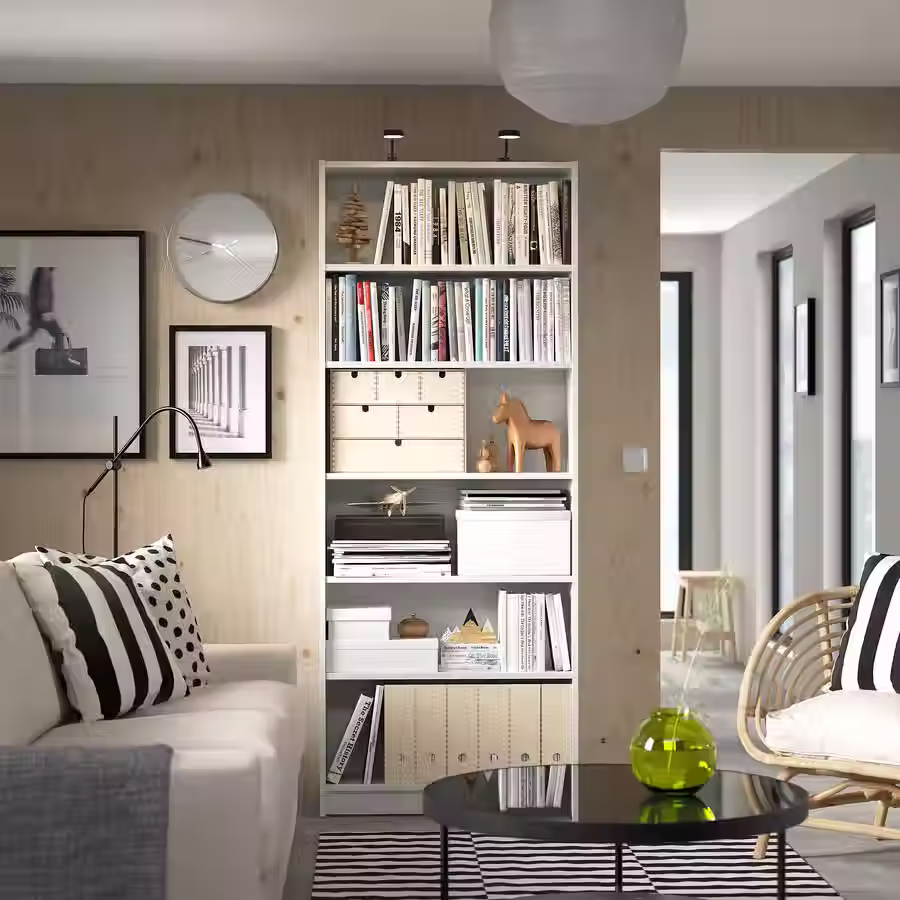 Studio apartment bookcase decorated with books, artwork, and personal trinkets that reflect the resident’s personality.