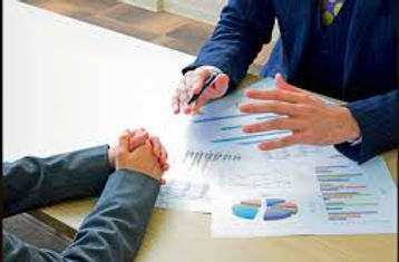 Preperation occurring as two arms work on a business document.