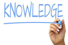 Hand underlines "KNOWLEDGE" written in blue on a white background, conveying a sense of importance and focus.