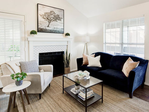 Cozy modern living space by fireplace and grey hardwood floors