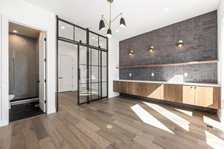 Custom built-in shelving and cabinetry in the living room add warmth and functionality while maintaining the home’s clean lines.