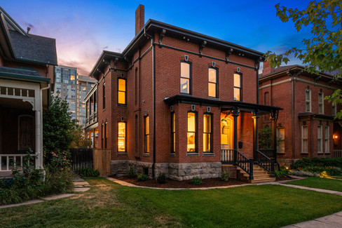 Warm lighting and classic detailing give the historic facade a welcoming glow after dark.