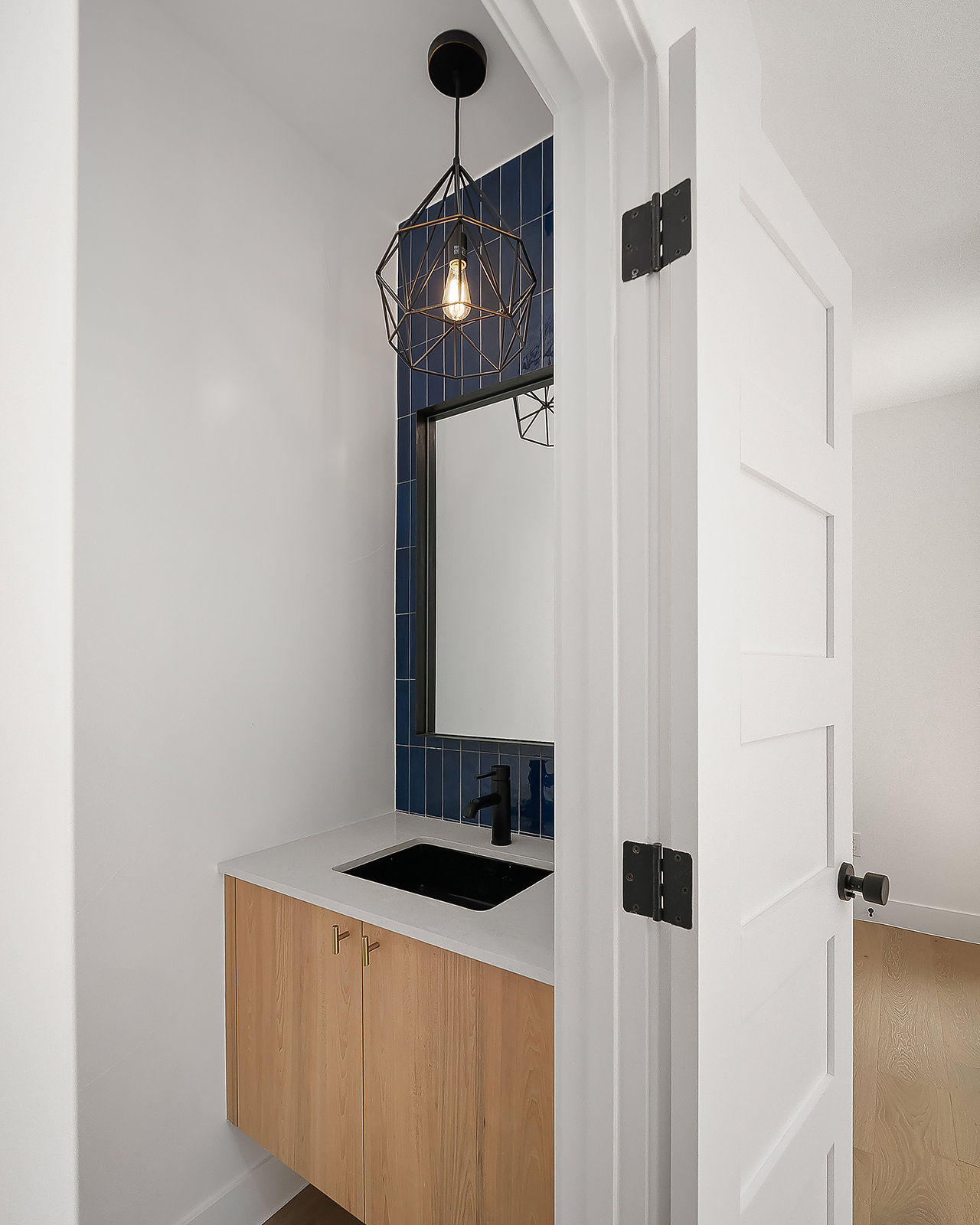 Even compact bathrooms feel elevated through custom finishes and soft lighting.