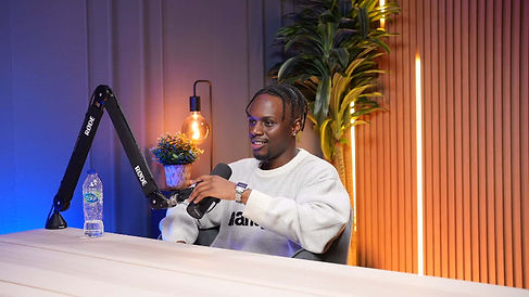 Male guest in white sweatshirt during podcast session at Dubai podcast studio setup podcast studio Dubai