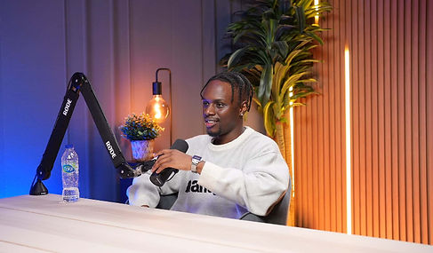 Male guest in white sweatshirt during podcast session at Dubai podcast studio setup podcast studio Dubai