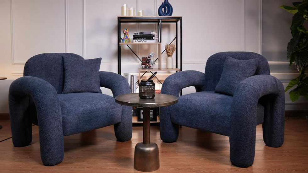 Cozy blue chairs, table and mic in Dubai podcast studio, a stylish podcast studio Dubai setup.